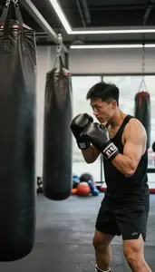 Boxing Coach Boxing With A Trainer In A Boxing Gym With Punching Bags In