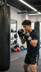 Boxing Coach Boxing With A Trainer In A Boxing Gym With Punching Bags At