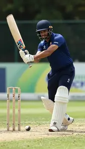 Cricket Coach Hitting A Cricket Ball On A Cricket Pitch In Daily Work