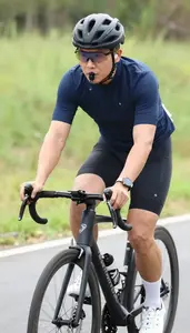 Cycling Coach Cycling On A Road On A Cycling Road Route In Professional Setting