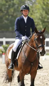 Equestrian Coach Riding A Horse In In An Equestrian Riding Arena At Work Today