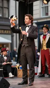 Magician Operating Puppets On A On A City Street As A Street Performer At