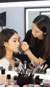 Makeup Artist Applying Professional Makeup To In A Wig Styling Workshop In Daily