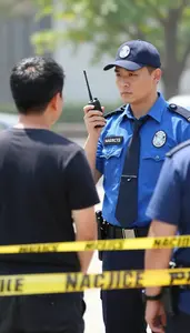 Narcotics Detective Conducting Surveillance On A At A Crime Scene With Police