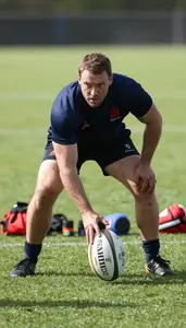 Rugby Coach Railing A Rugby Ball On A Rugby Field At Professional Location