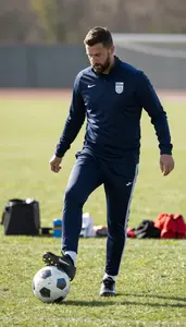Soccer Coach Kicking A Soccer Ball On A Soccer Match Field In Daily Work