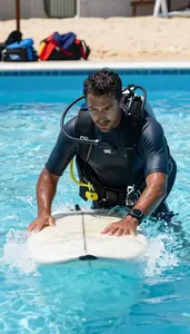 Surfing Instructor Instructing Surfing On A Underwater In A Scuba Training Pool
