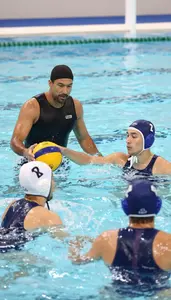 Surfing Instructor Coaching Water Polo Players In A Water Polo Pool At Workplace