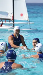 Swimming Coach Coaching Water Polo Players On Open Ocean Sailing Waters At Work