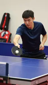 Table Tennis Coach Hitting A Table Tennis At A Table Tennis Table In