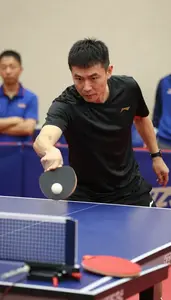 Table Tennis Coach Hitting A Table Tennis At A Table Tennis Table At Work