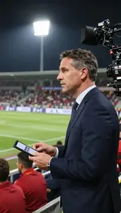 Team Owner Commentating On A Sports At A Sports Event From The Stands In