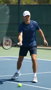 Tennis Coach Playing Tennis On A On A Tennis Court At Professional Location