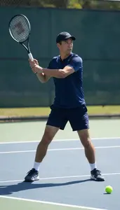 Tennis Coach Playing Tennis On A On A Tennis Court In Professional Setting