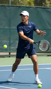 Tennis Coach Playing Tennis On A On A Tennis Court At Workplace