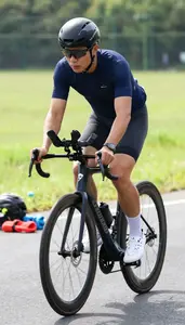 Triathlon Coach Cycling On A Road On A Cycling Road Route At Professional Venue