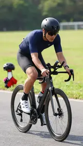 Triathlon Coach Cycling On A Road On A Cycling Road Route In Professional