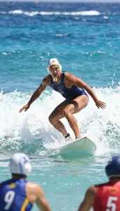 Water Polo Coach Surfing On A Wave On A Beach With Ocean Waves At Work Location