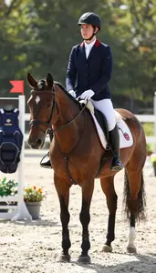 Horse Riding Instructor Riding A Horse In In An Equestrian Riding Arena In Daily