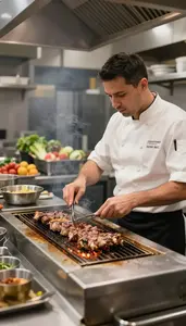 Line Cook Grilling Meat On A At A Restaurant Grill Station At Workplace