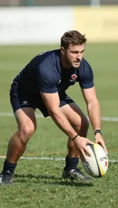 Rugby Coach Railing A Rugby Ball On A Rugby Field At Work Location