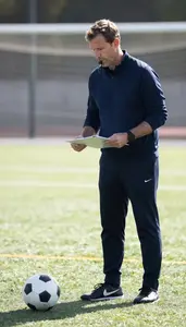 Soccer Coach Coaching A Soccer Team On A Soccer Field During Practice In Daily