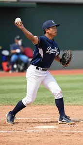 Softball Coach Pitching A Baseball On On A Baseball Diamond In Daily Work