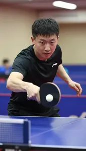 Table Tennis Coach Hitting A Table Tennis At A Table Tennis Table At