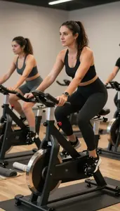 Zumba Instructor Leading A Spin Class In A Spin Studio With Stationary Bikes