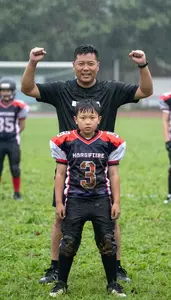 Dad Cheering In The Rain At His Sons Muddy Football Game