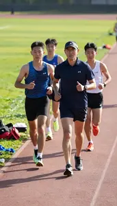 Track And Field Coach Coaching Marathon Runners Running Trail In Professional
