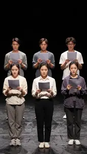 Actors Rehearsing Lines With Scripts On A Black Box Theater Stage