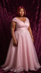African Woman In Her 40s With Fat With Red Bob Haircut Wearing Orchid Flowing A