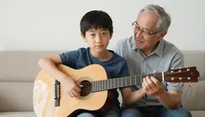 Boy Learning To Play Acoustic Guitar From His Patient Grandfather