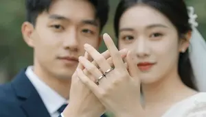 Close Up Of A Couples Intertwined Fingers Showing Wedding Bands