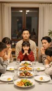 Close Knit Family Praying Together Before A Holiday Meal At Table