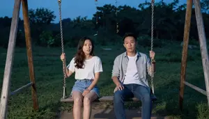 Couple Having A Deep Conversation On A Swing Set At Twilight