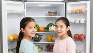 Family Peering Into An Empty Open Fridge Deciding What To Cook
