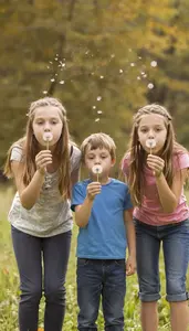 Family Of Three Blowing Dandelion Seeds Into The Golden Wind