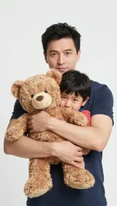 Father Comforting His Crying Child With A Tight Bear Hug
