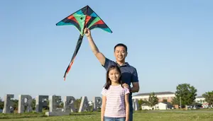 Father And Daughter Flying Kite On Memorial Day