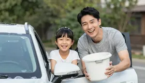 Father And Daughter Laughing While Washing A Car With Bubbles