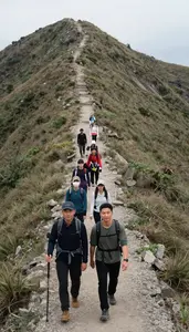 Friend Group Hiking Up A Steep Mountain Ridge Trail Single File