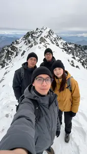 Friends Taking A Selfie At The Summit Of A Snowy Mountain Hike