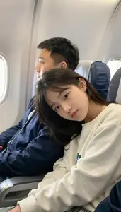 Girl Resting Her Head On Her Fathers Shoulder During A Flight