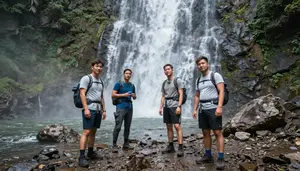 Hikers Taking A Water Break On A Rocky Trail Overlooking A Waterfall