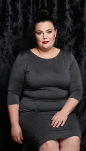 Scandinavian Woman In Her 50s With Extra Fat With Black Bun Updo Wearing